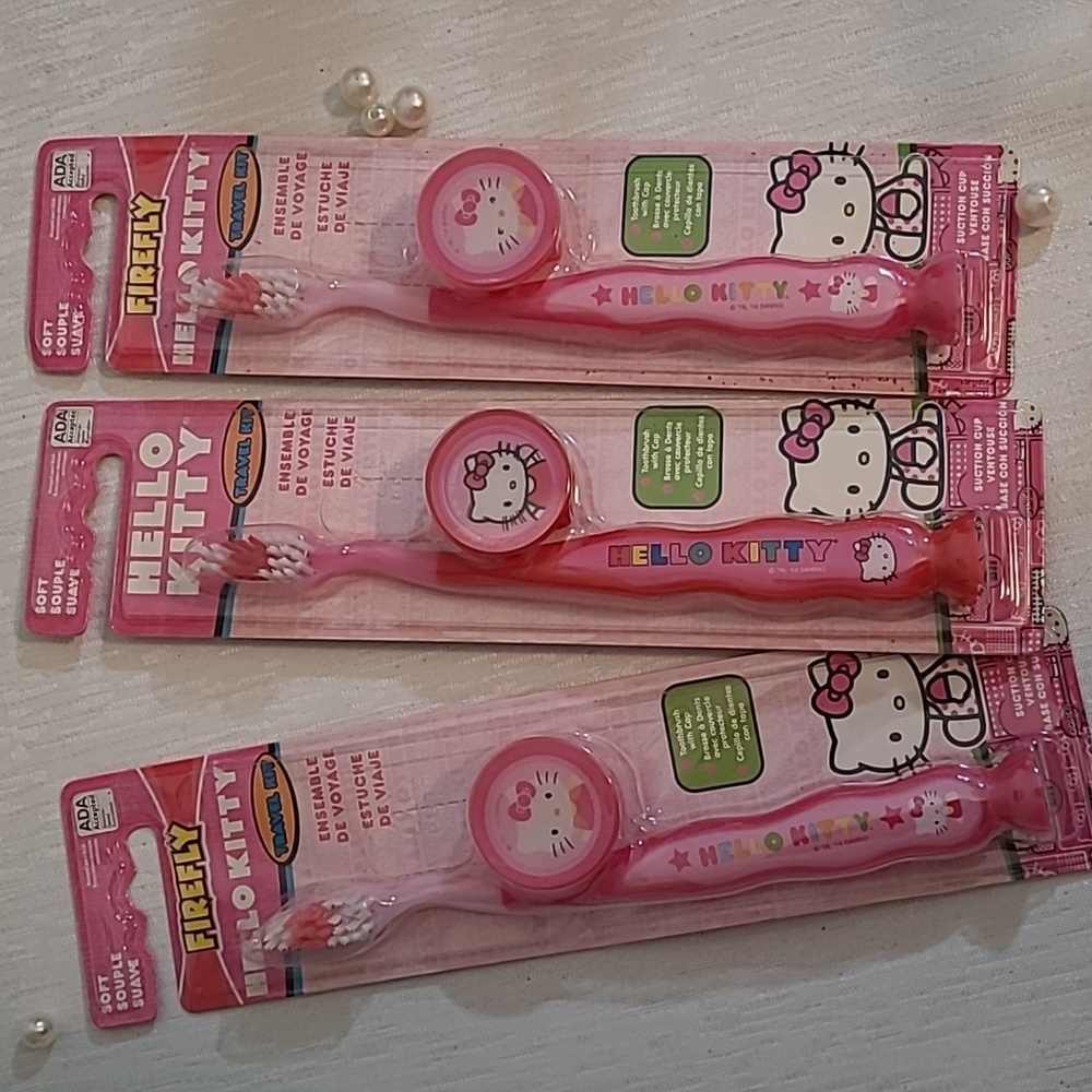 NEW set of 3 Fire fly Hello Kitty tooth brushes and holders